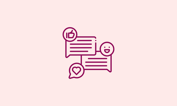 Two speech bubbles with a smiley face and a heart